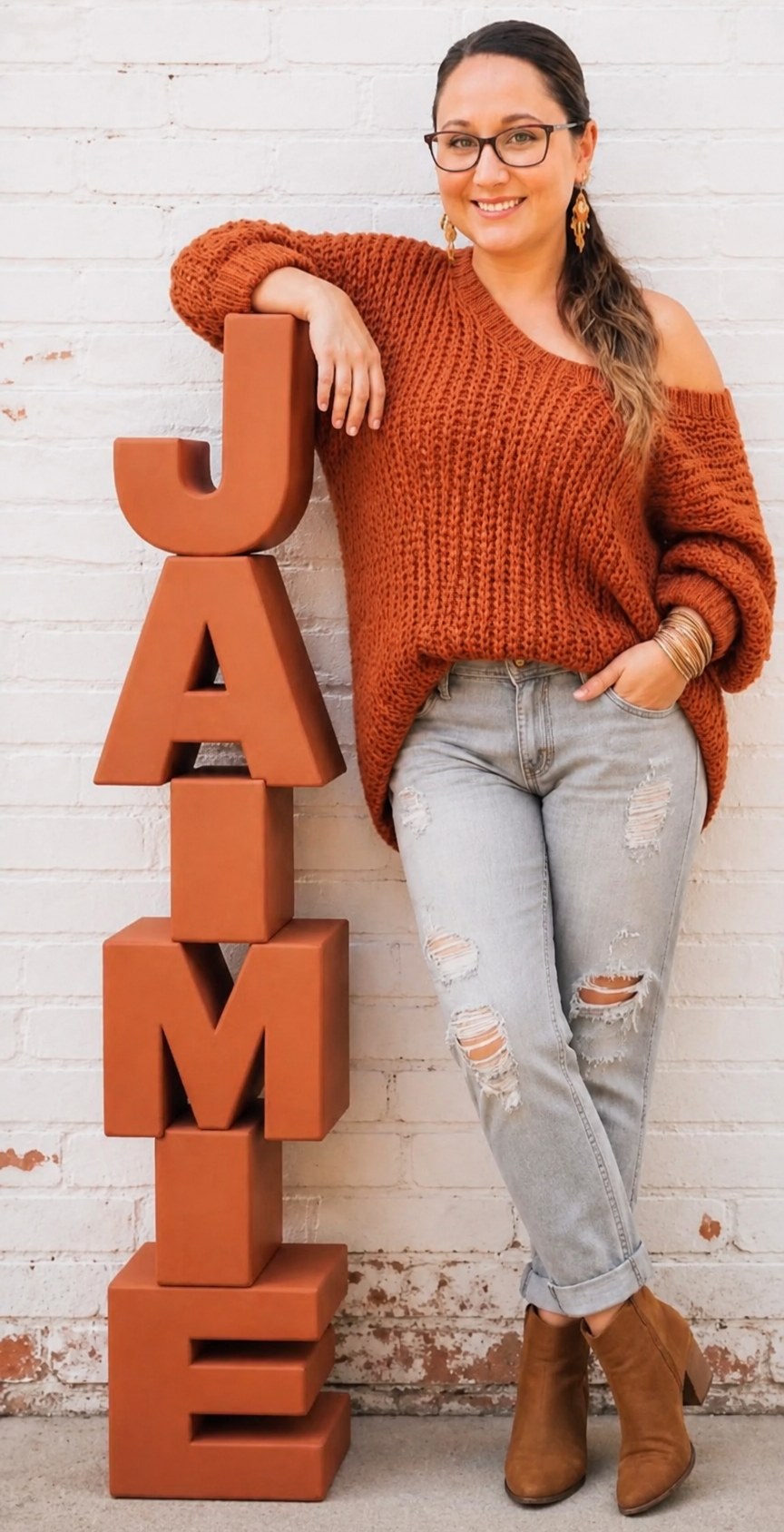 Jaimie Kozyra standing beside letters spelling her name
